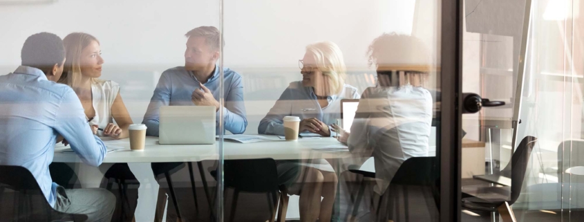 Business people negotiating at boardroom behind closed doors