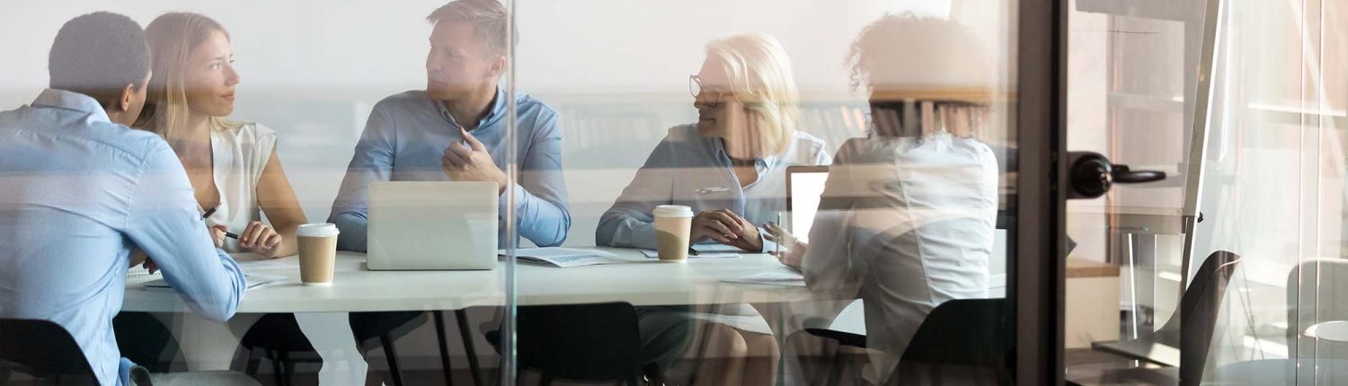 Business people negotiating at boardroom behind closed doors