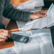 How-to-Address-Past-Due-Invoices Man looking at financial documents and using calculator