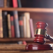 Image of a gavel with books in the background