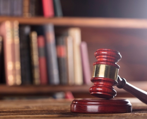 Image of a gavel with books in the background