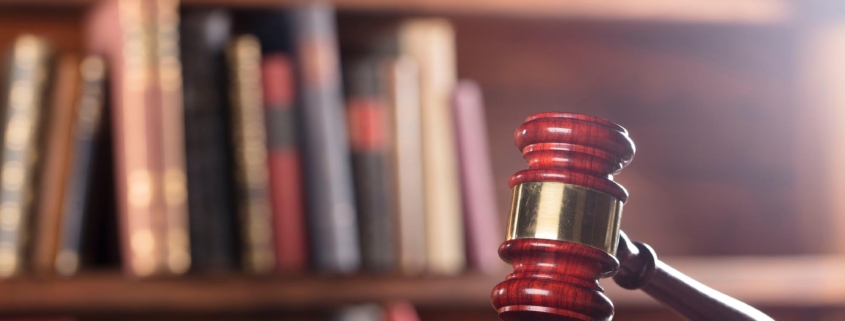 Image of a gavel with books in the background
