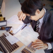 Selective-focus-of-man-hand-with-many-debts-of-credit-caards-which-he-is-thinking-how-to-pay-off-debts Man stressed with many credit cards wondering how to pay off debts