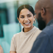A business woman and business man discussing something and smiling