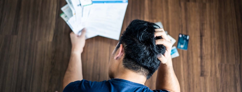 man stressed handling bills