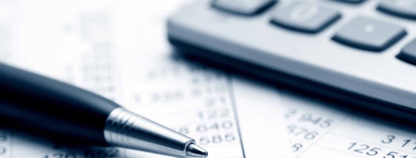 Close up of a pen and calculator