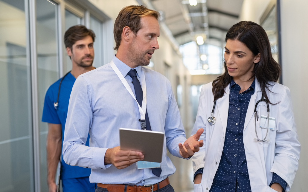 Doctor Talking to Consultant in Hallway Doctor Talking To Consultant In Hallway