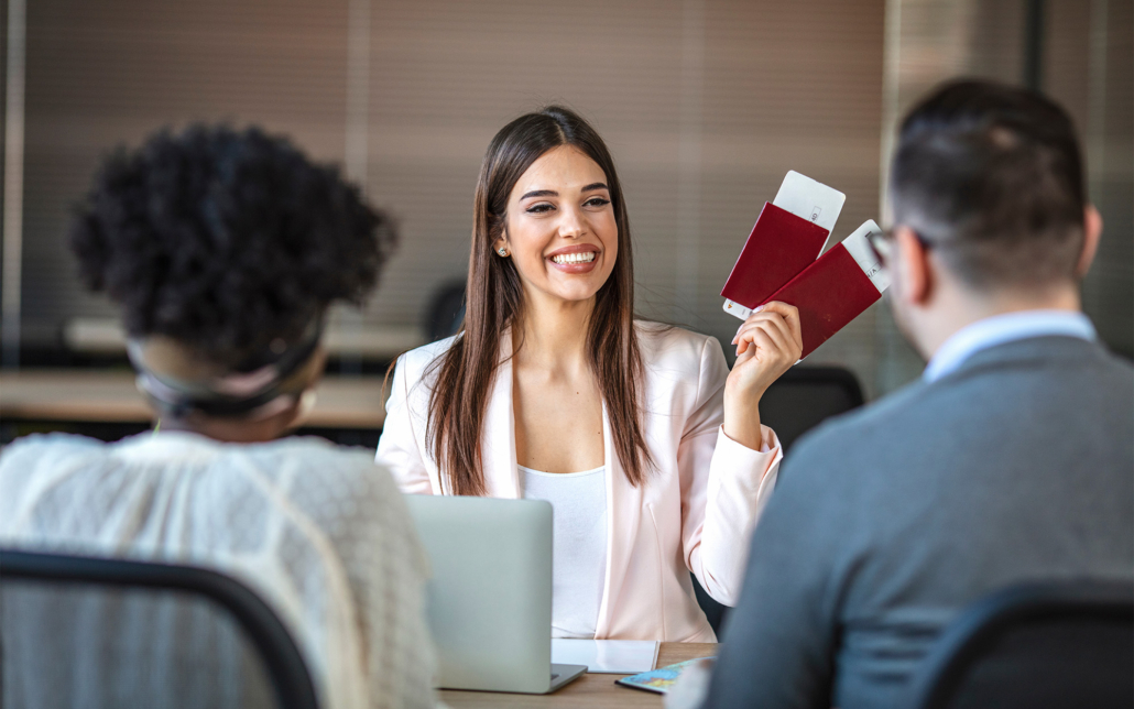 Smiling Travel Agent Showing Couple Passports