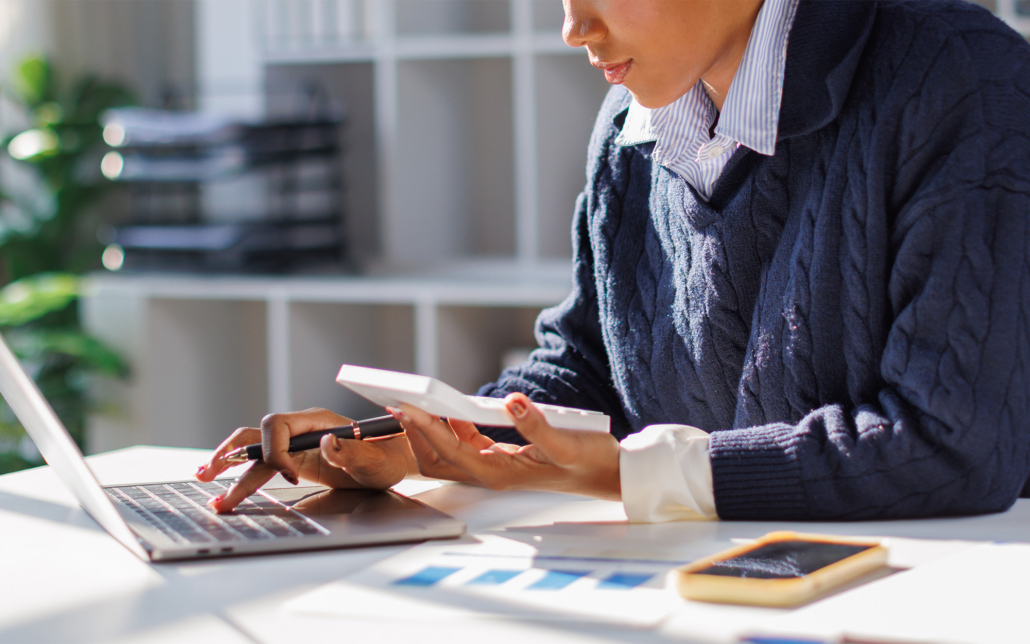 Business Person Looking At Invoices At Office Desk
