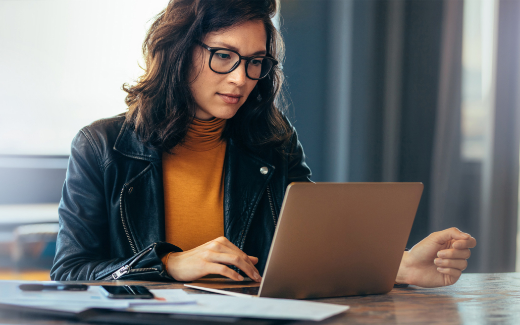 Asian Business Woman Working On A Laptop In A Professional Office