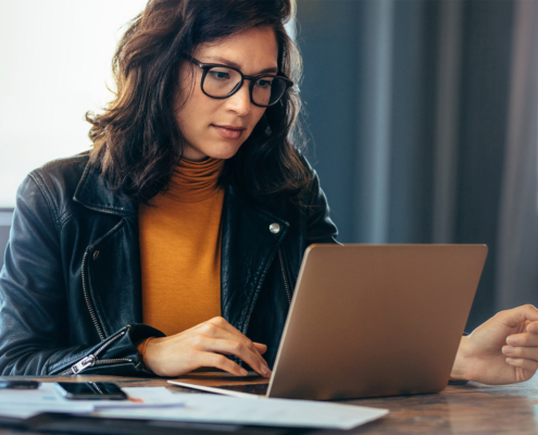 Asian Business Woman Working On A Laptop In A Professional Office