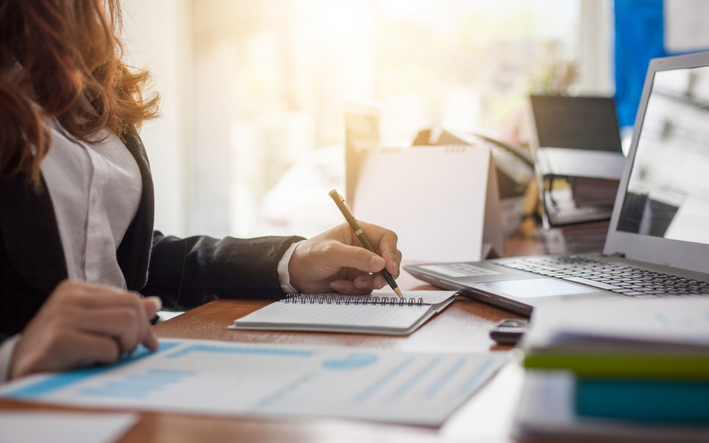 Business Woman At Working With Financial Reports And Laptop Computer In The Office