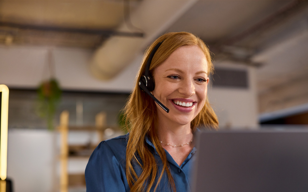 Customer Care Redhead Woman Working In A Casual Call Center