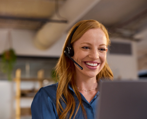 Customer Care Redhead Woman Working In A Casual Call Center