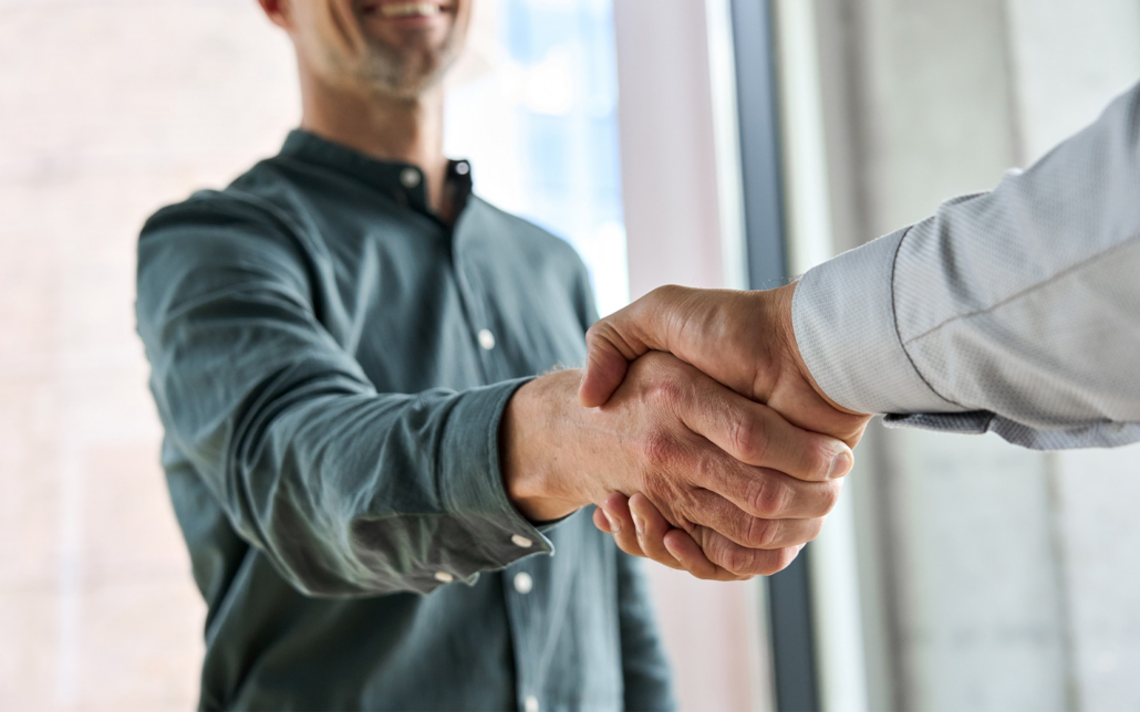 Two Happy Diverse Professional Business Men Executive Leaders Shaking Hands At Office Meeting